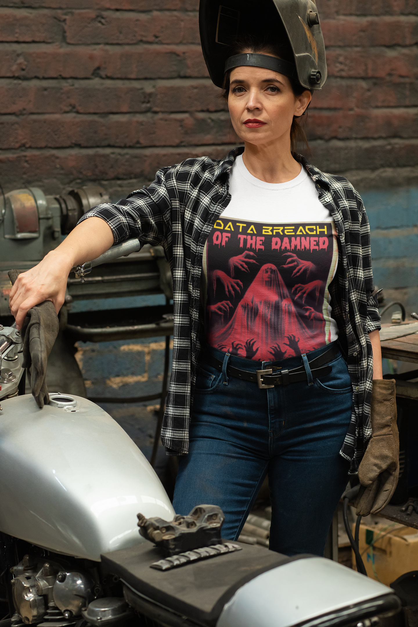 Woman working on her motorcycle wearing data breach of the damned t-shirt