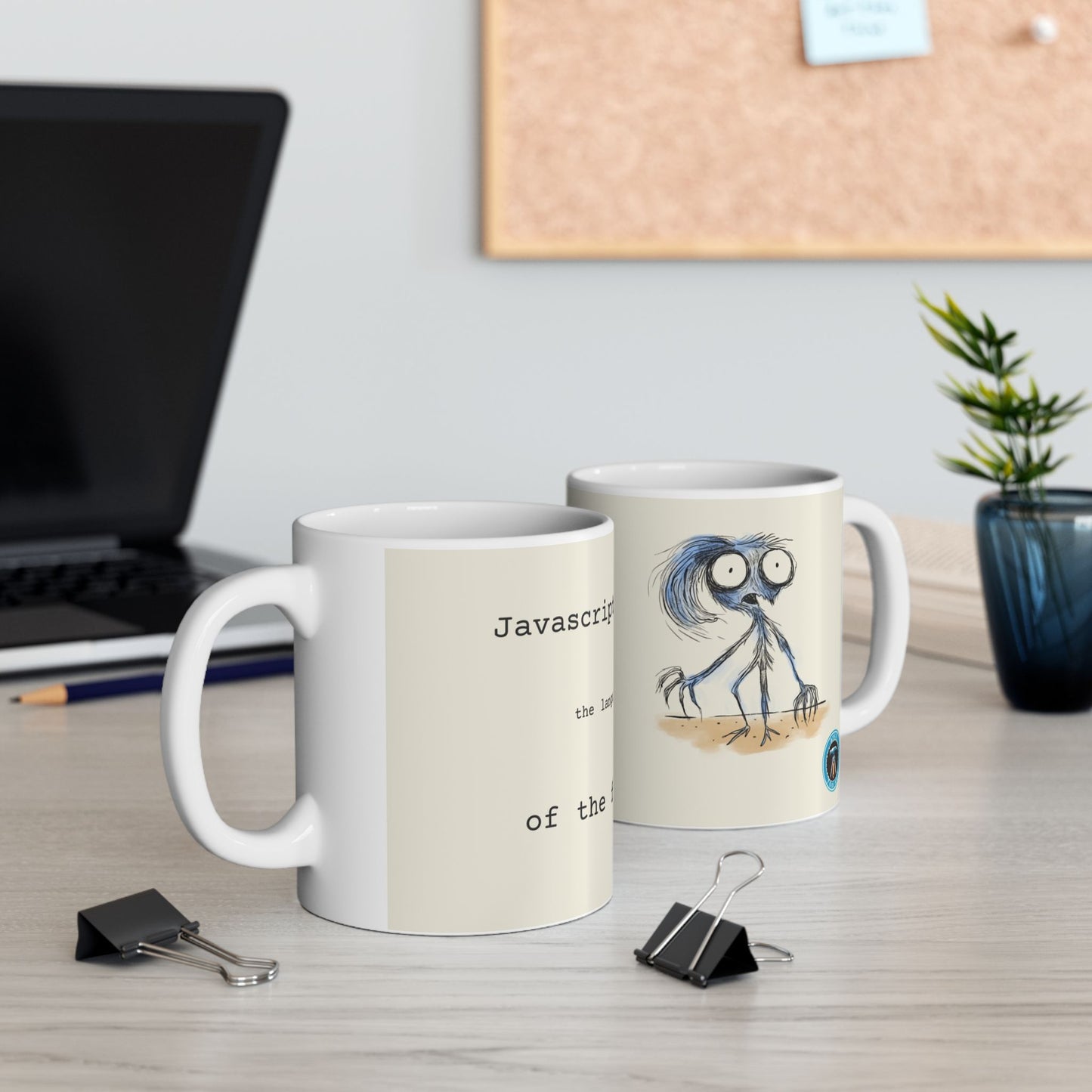 JavaScript; Language of the future cups in front of a laptop and cork board