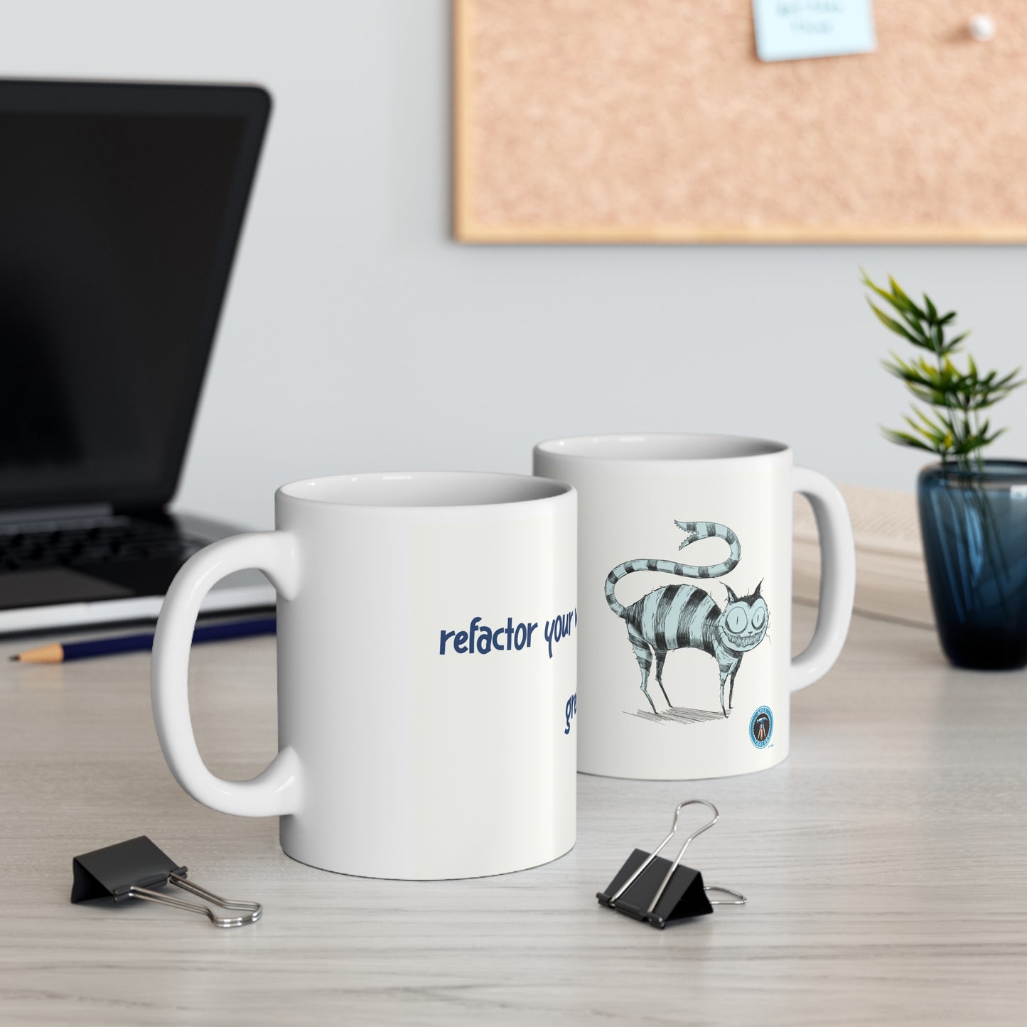 Refactor your way to greatness cups on a desk with laptop, cork board and plant in background